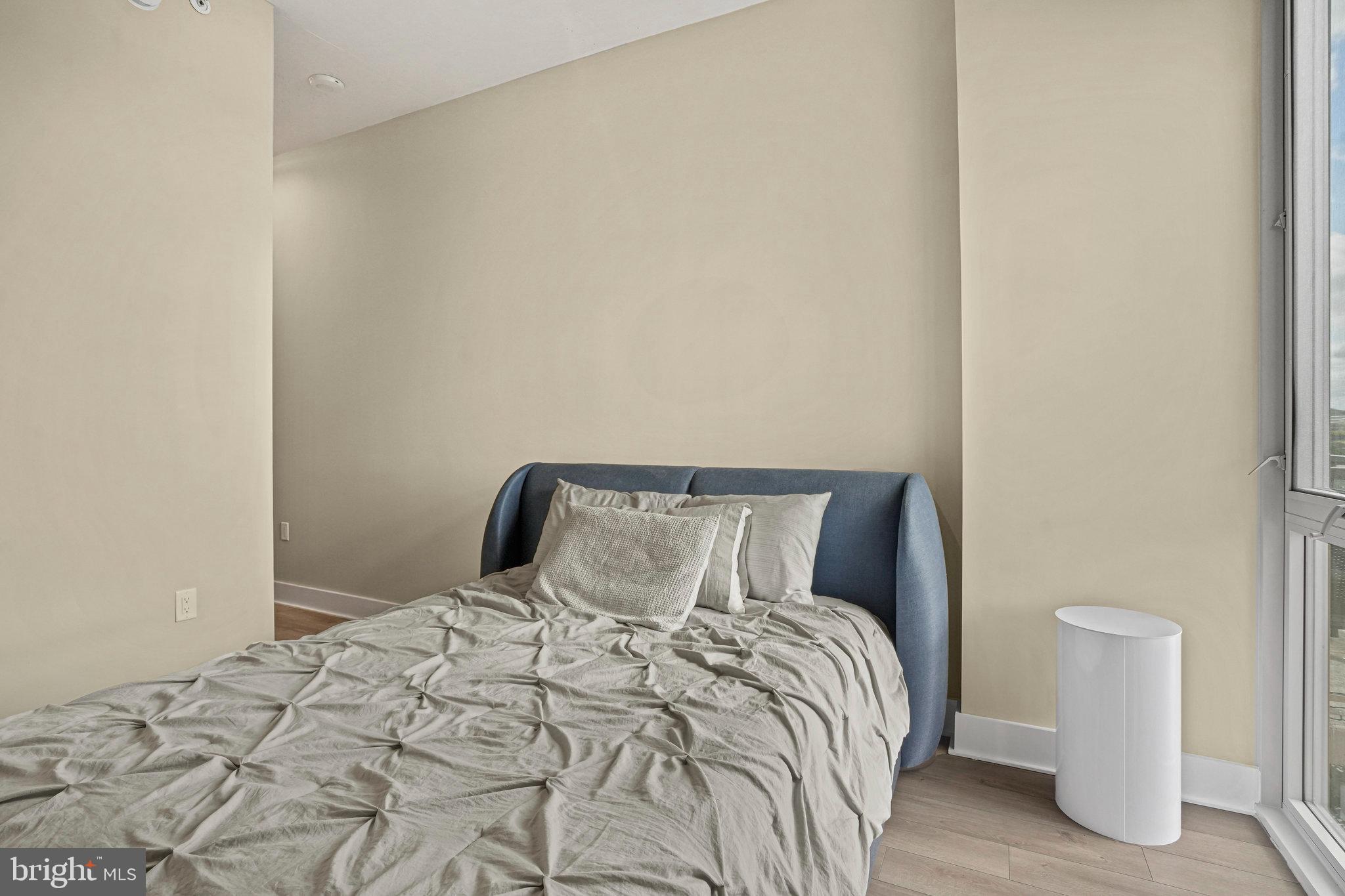 88 V Street Southwest, Unit 807 Washington, DC 20024 - Photo 27 of 57 a bedroom with a bed and a wall painting