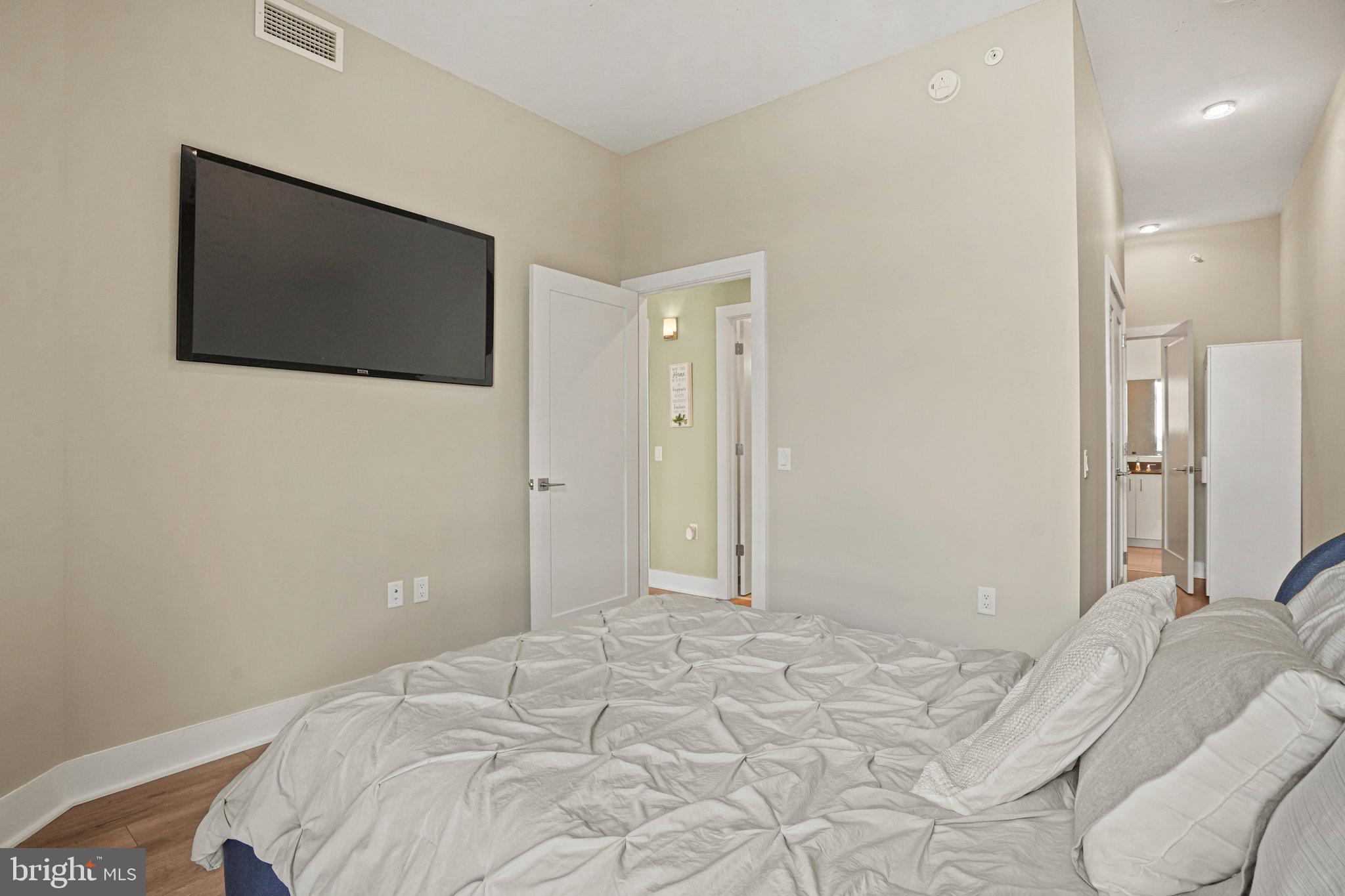 88 V Street Southwest, Unit 807 Washington, DC 20024 - Photo 28 of 57 a bedroom with a bed and a flat screen tv