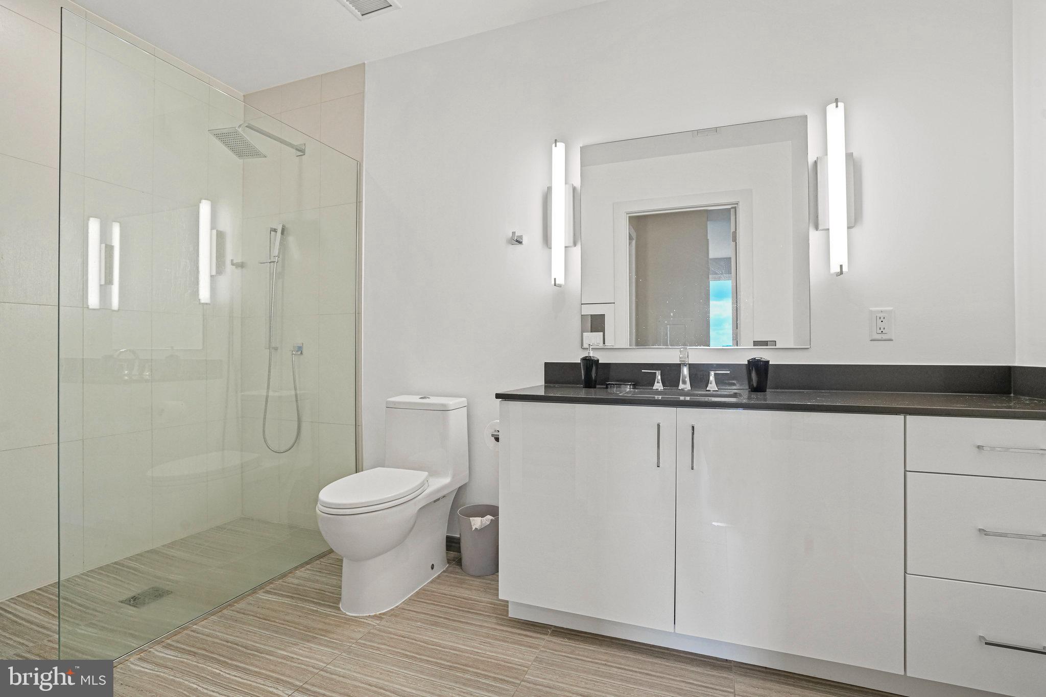 88 V Street Southwest, Unit 807 Washington, DC 20024 - Photo 29 of 57 a bathroom with a toilet sink and a mirror