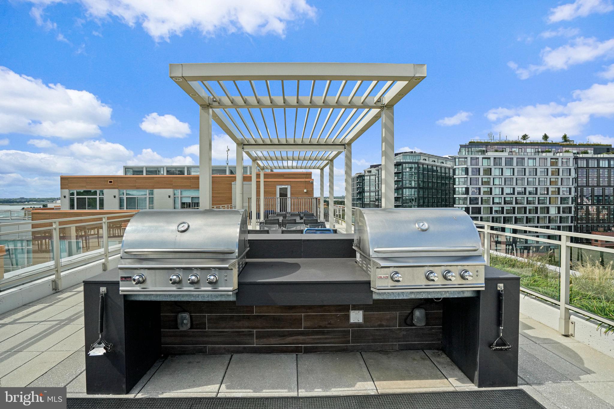 88 V Street Southwest, Unit 807 Washington, DC 20024 - Photo 36 of 57 a view of a roof deck with table and chairs