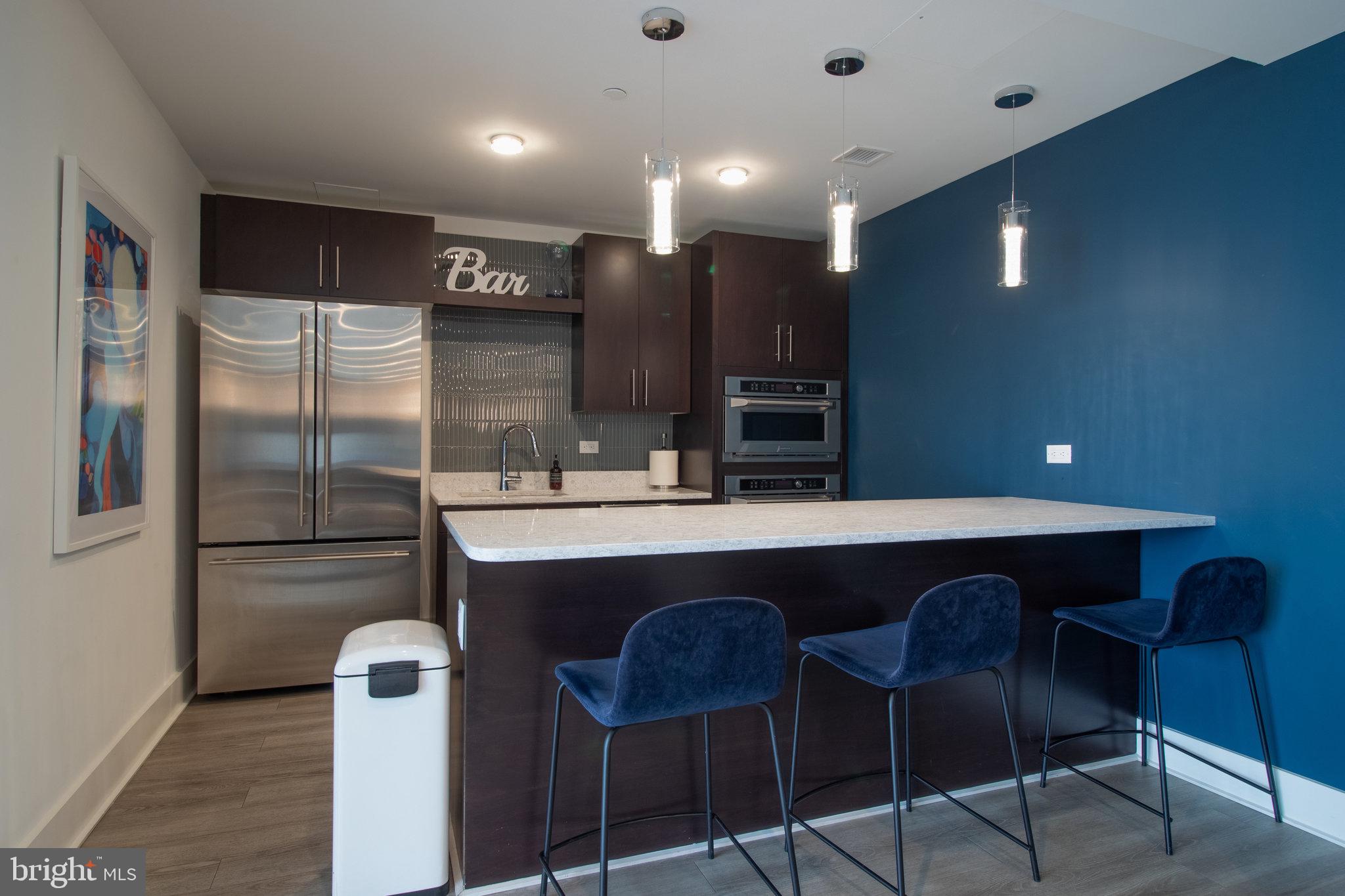 88 V Street Southwest, Unit 807 Washington, DC 20024 - Photo 54 of 57 a kitchen with stainless steel appliances granite countertop a sink and a refrigerator