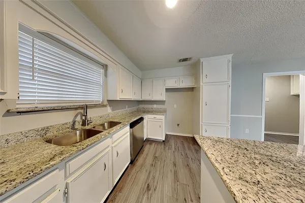 a kitchen with a sink stove and refrigerator