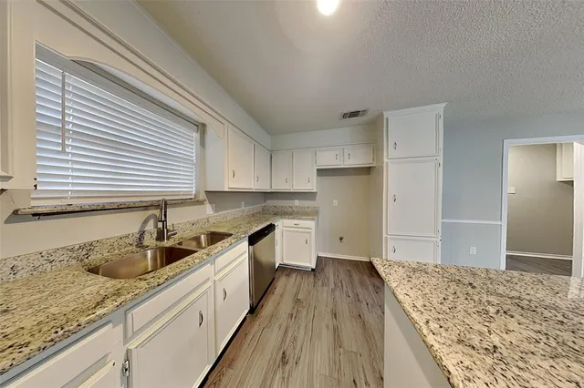a kitchen with a sink stove and refrigerator