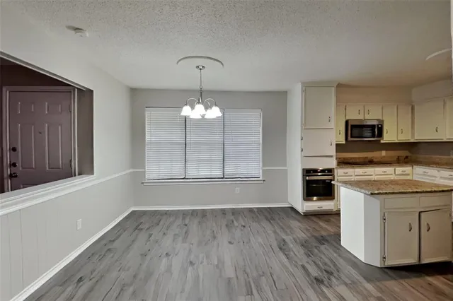 a view of a kitchen counter space wooden floor and a window
