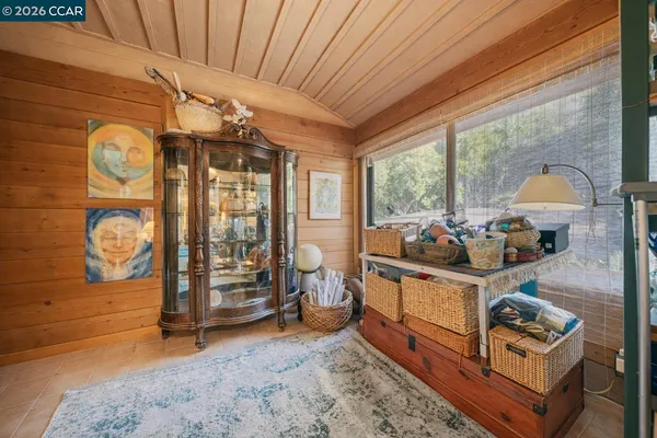 a bedroom with a bed and a dresser next to a window