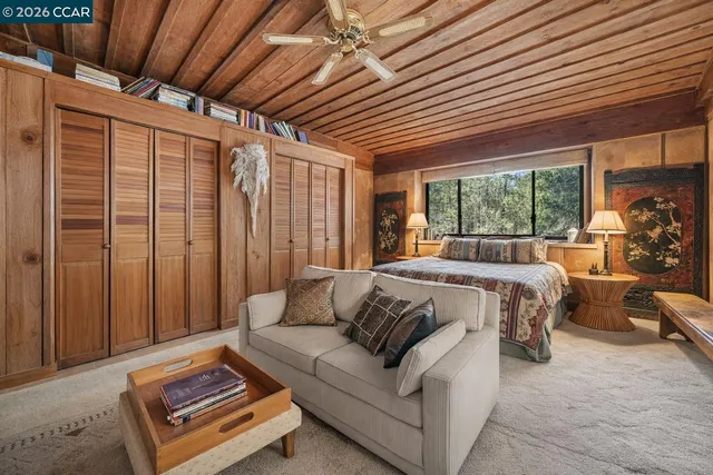 a bed sitting in a bedroom next to a window