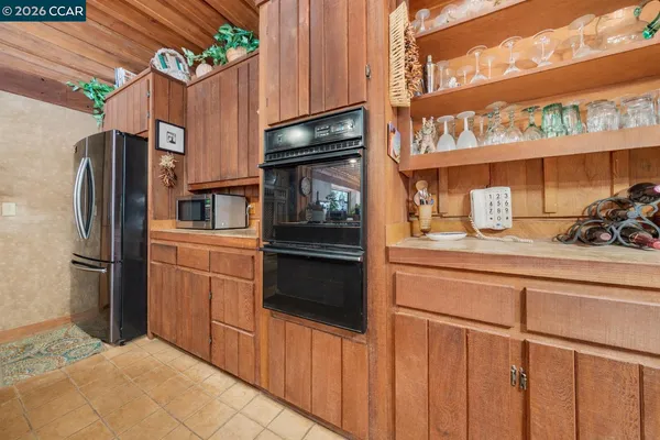 a kitchen with stainless steel appliances a refrigerator and a stove