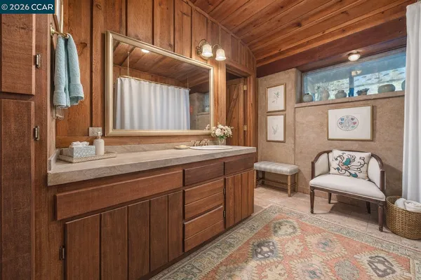 a view of a house with backyard garden and trees