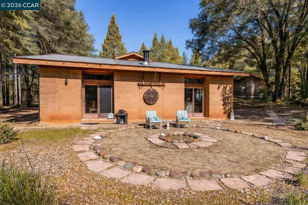 a view of a house with a yard and a garage