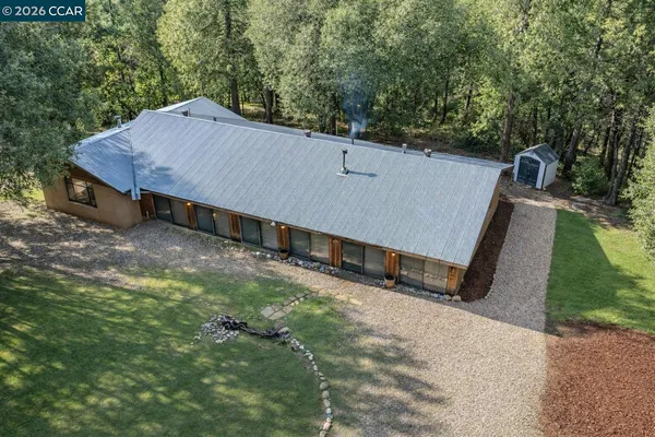 an aerial view of a house with a yard