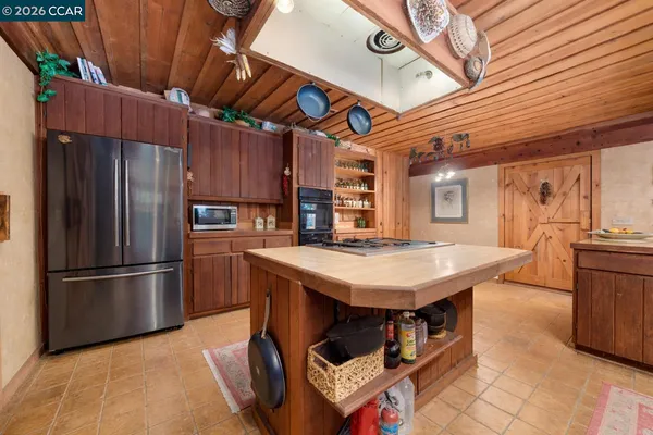 a kitchen with a stove a sink a counter top space and appliances