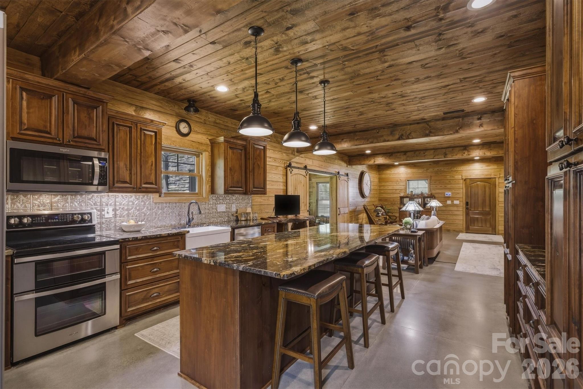 7490 Oak Ridge Church Road Connelly Springs, NC 28612 - Photo 16 of 44 a kitchen with lots of counter top space and stainless steel appliances