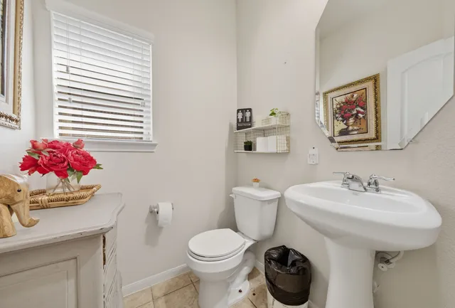 a bathroom with a sink mirror and toilet