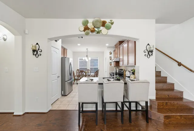 a view of a dining room with furniture and wooden floor