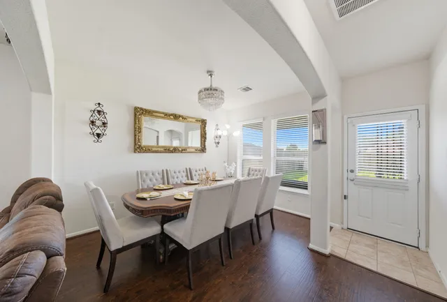 a dining room with furniture a rug and wooden floor