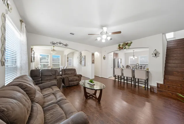 a living room with furniture and wooden floor