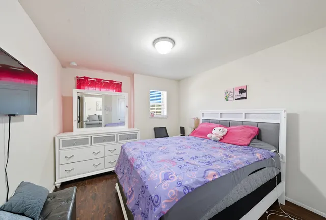 a bedroom with a bed and a dresser