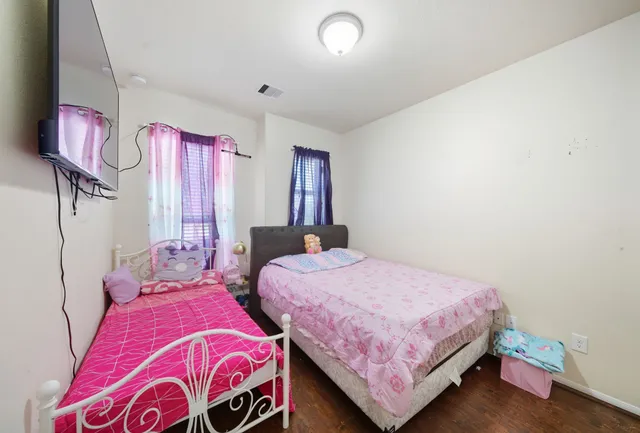 a bedroom with two beds and a window