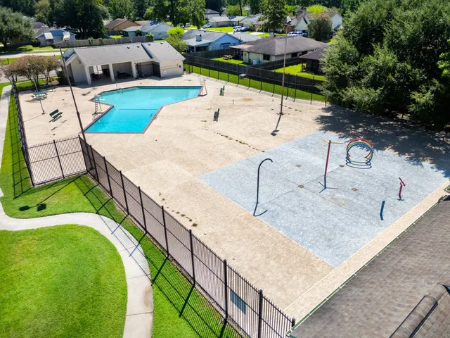 an aerial view of a house with swimming pool and outdoor seating