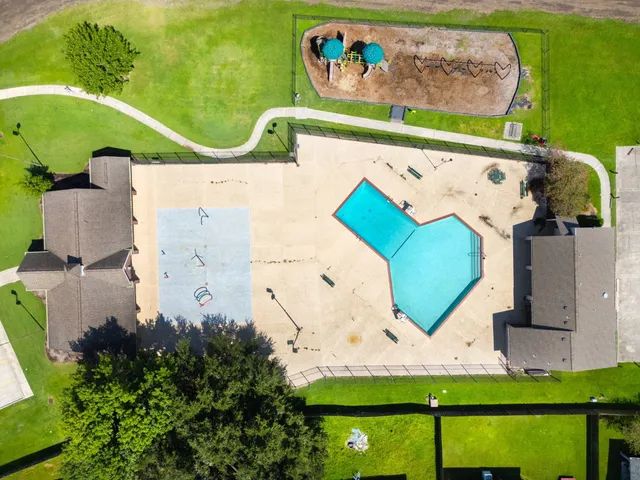 an aerial view of a house with a swimming pool
