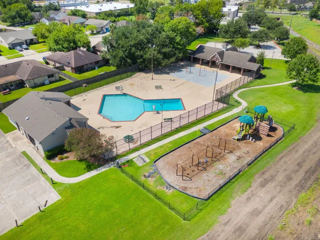 an aerial view of a house with a garden and swimming pool
