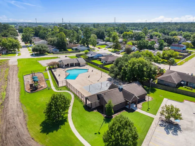 an aerial view of a house with yard swimming pool and outdoor seating