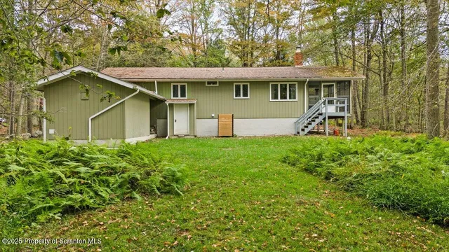 a front view of a house with yard and green space
