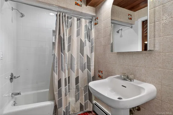 a bathroom with a sink a shower curtain and a sink