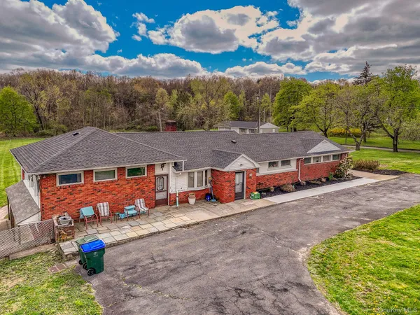 an aerial view of a house with a yard