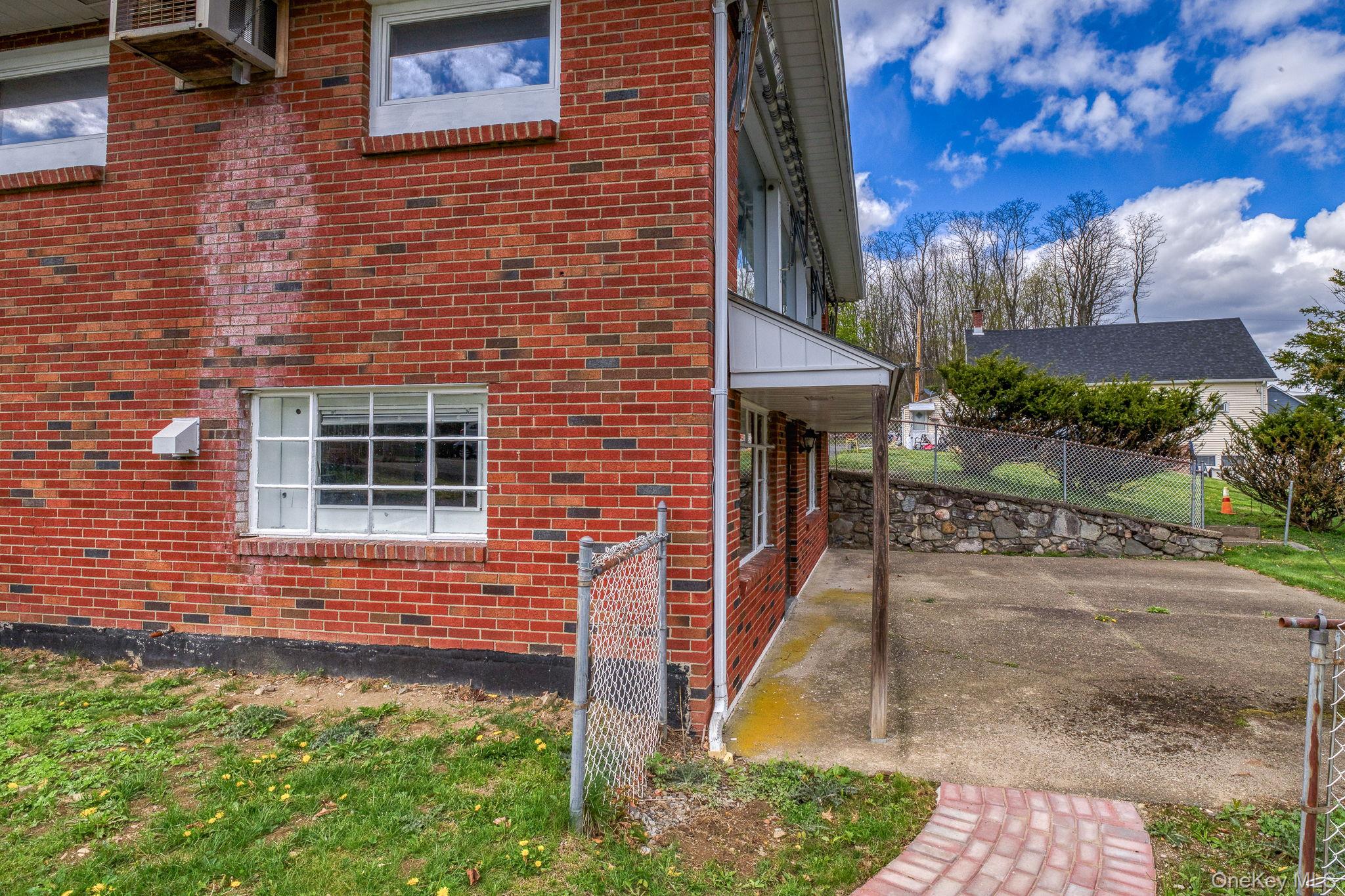 353 Candlestick Hill Road Newburgh, NY 12550 - Photo 17 of 19 a brick building with a tree in front of it