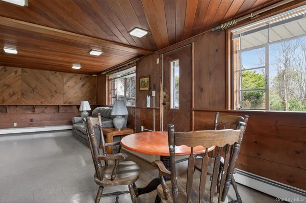 a view of a dining room with furniture window and outside view