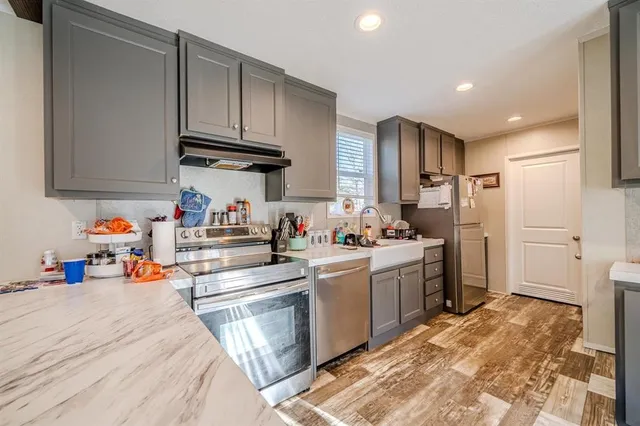 a kitchen with a sink cabinets and stainless steel appliances