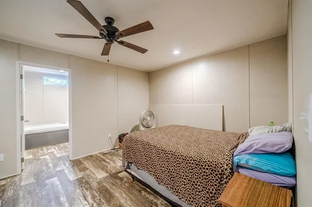 a bedroom with a bed and a ceiling fan