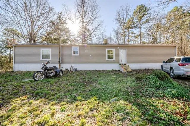 a backyard of a house with yard and outdoor seating
