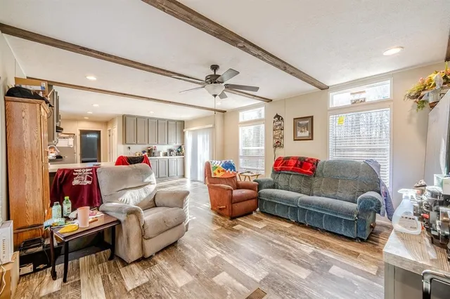 a living room with furniture and a chandelier
