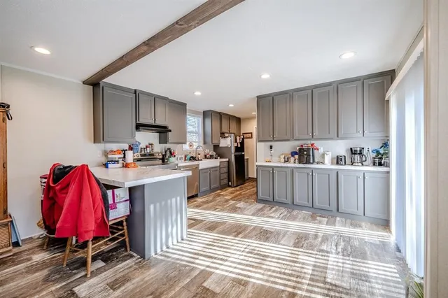 a kitchen with stainless steel appliances granite countertop a refrigerator sink and cabinets