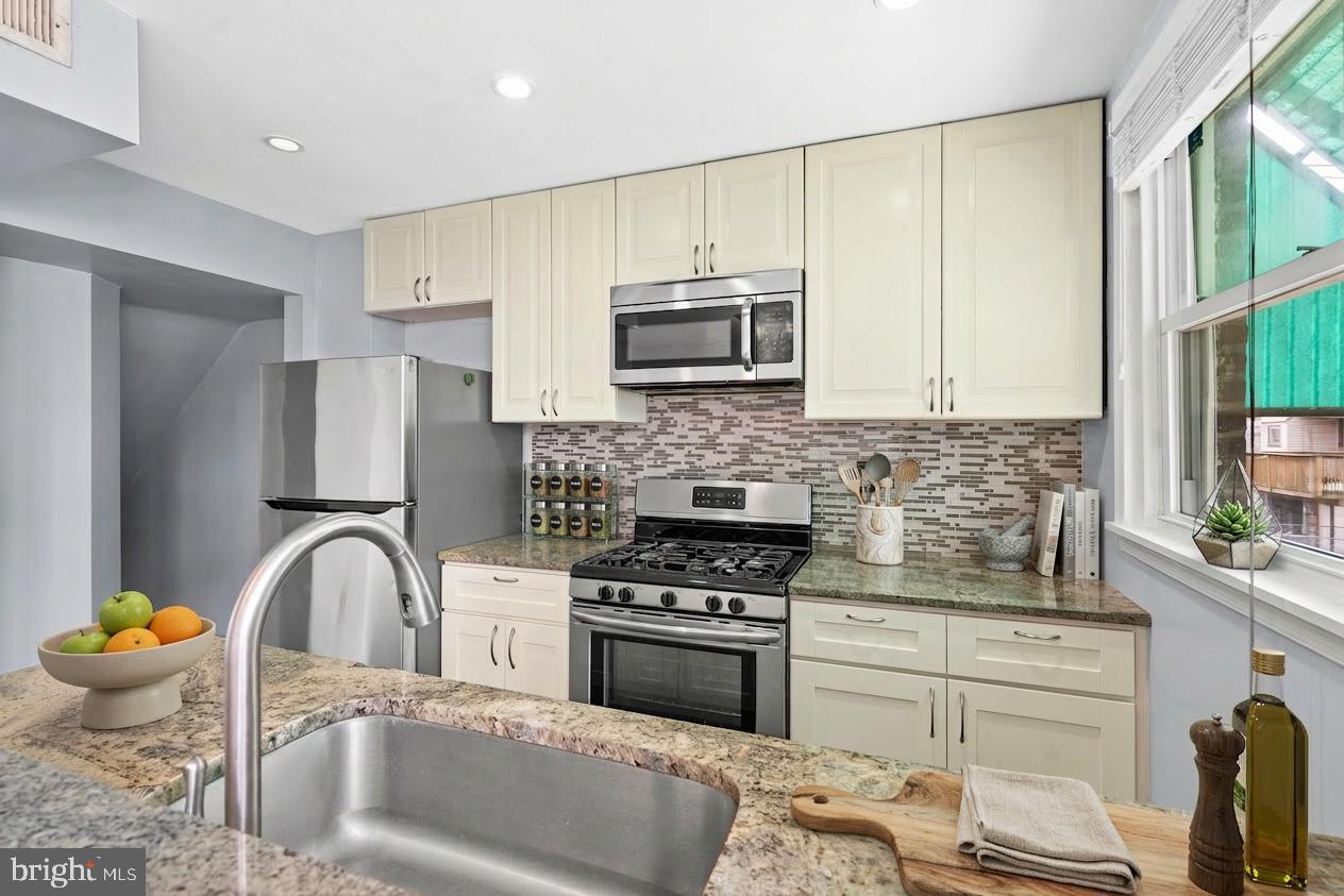 3522 Meridian Street Philadelphia, PA 19136 - Photo 5 of 18 a kitchen with a stove a sink and a microwave