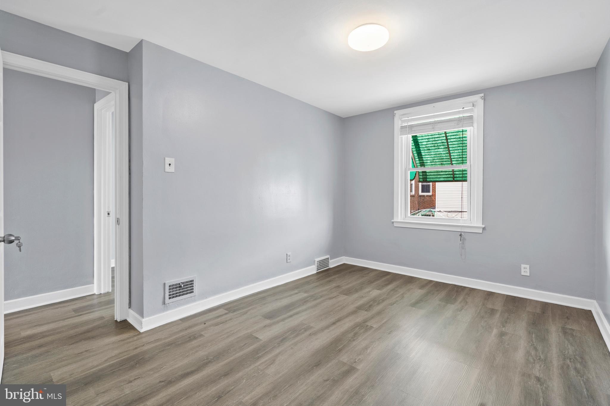3522 Meridian Street Philadelphia, PA 19136 - Photo 10 of 18 a view of an empty room with wooden floor and a window
