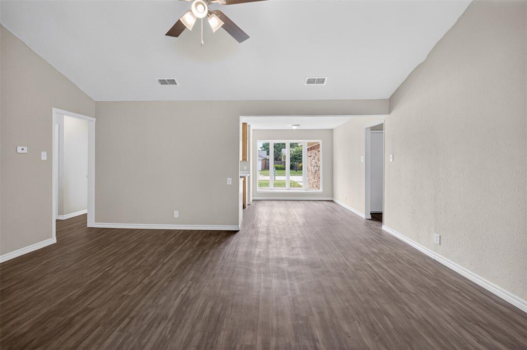 7528 Meadowlark Lane North Watauga, TX 76148 - Photo 4 of 31 an empty room with wooden floor and windows