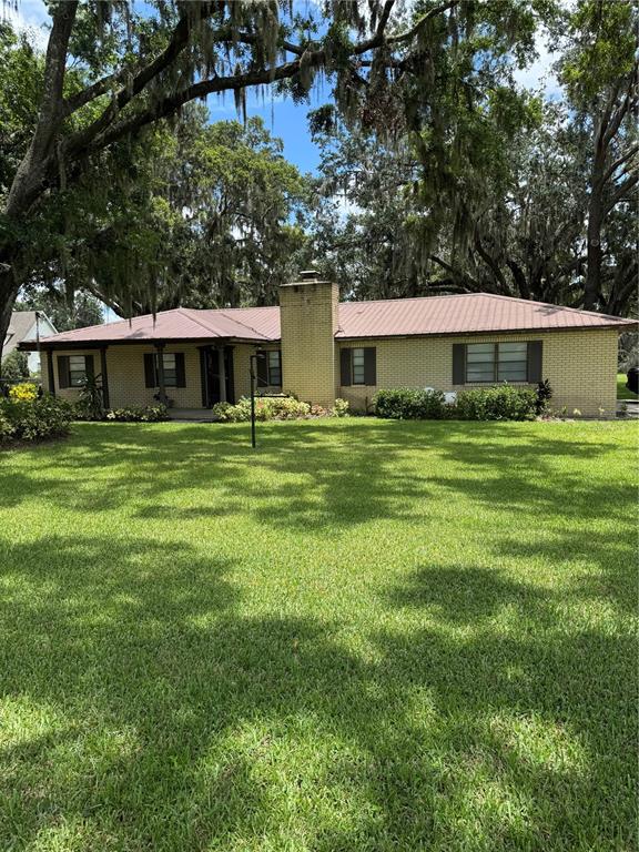 a front view of house with yard and trees