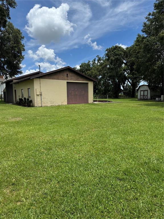 4106 Old Mulberry Road Plant City, FL 33567 - Photo 18 of 52 a yellow house with a yard in front of it
