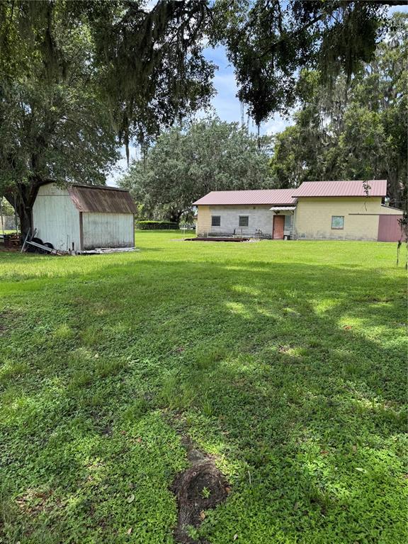 4106 Old Mulberry Road Plant City, FL 33567 - Photo 19 of 52 a front view of house with yard and trees in the background