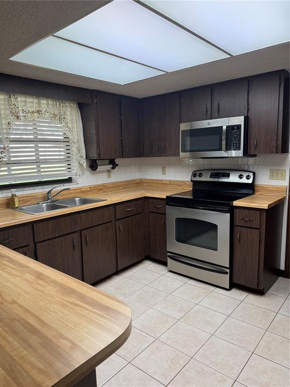 4106 Old Mulberry Road Plant City, FL 33567 - Photo 27 of 52 a kitchen with stainless steel appliances a stove sink and microwave