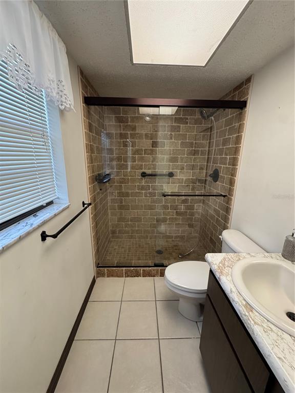 4106 Old Mulberry Road Plant City, FL 33567 - Photo 28 of 52 a bathroom with a granite countertop toilet a sink a shower and mirror
