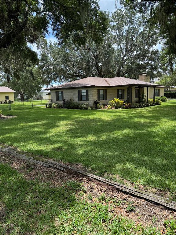 4106 Old Mulberry Road Plant City, FL 33567 - Photo 4 of 52 a front view of a house with a garden