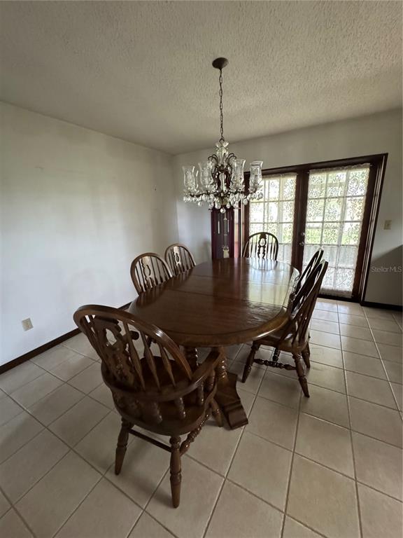 4106 Old Mulberry Road Plant City, FL 33567 - Photo 42 of 52 a dining room with furniture and chandelier