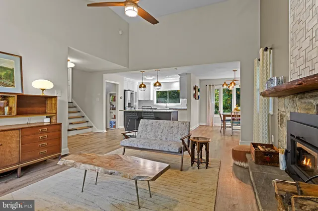 a living room with furniture a fireplace and a flat screen tv