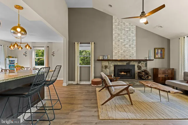 a living room with dining table and a fireplace