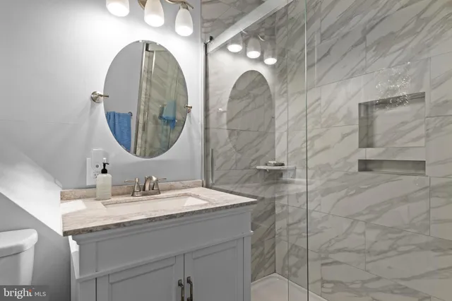 a bathroom with a double vanity sink and a mirror