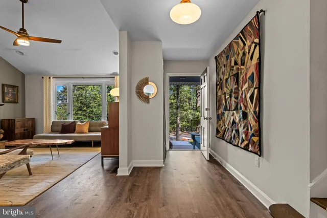 a view of a livingroom with furniture hardwood floor and a window